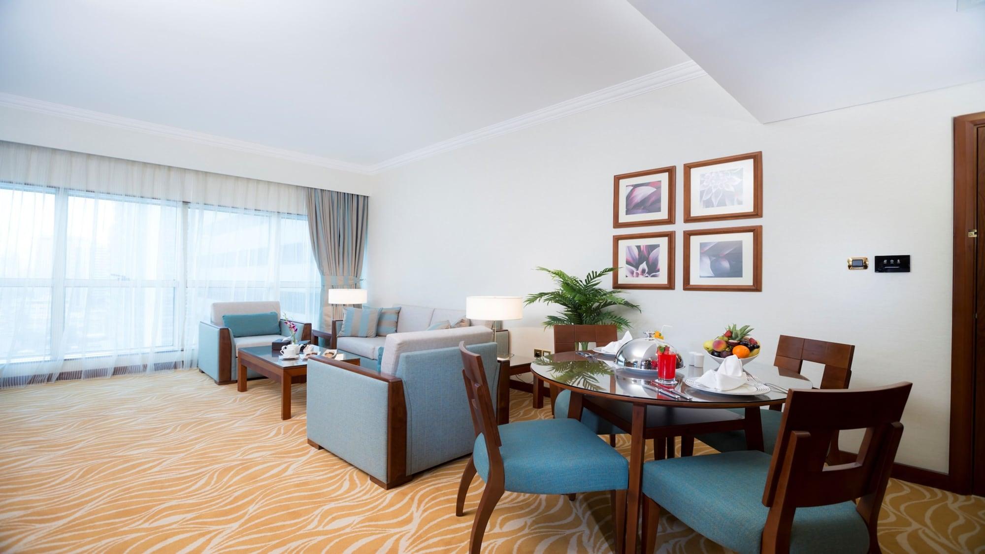Grand Mercure Majlis Residences Abu Dhabi Exterior foto A living room in a suite at the Jumeirah Beach Hotel